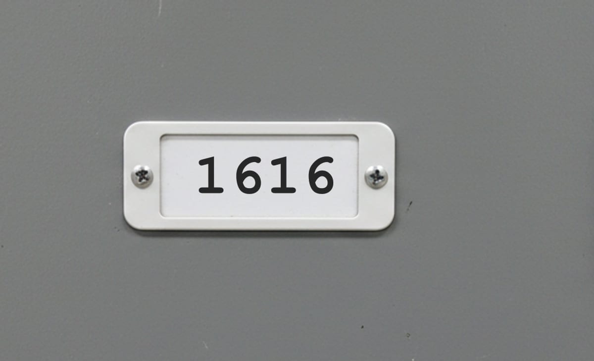 An office locker door with a small white plate numbered 1616.